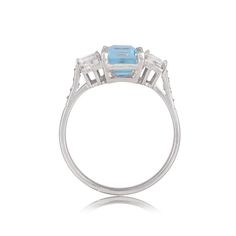 This beautiful aquamarine is set in between two baguette-cut diamonds on either side. The center gem is prong-set and lead towards an open gallery, made from handcrafted platinum. ✦ AQUAMARINE SPECIFICATIONS: Aquamarine Cut: Emerald Cut ✦ ENGAGEMENT RING SPECIFICATIONS: Ring Material: Platinum Stones: Aquamarine, Diamond ✦ WHAT COMES IN YOUR SHIPMENT: - Your Engagement Ring - Quality Ring Box - Jewelry Cleaner - UGL Certificate ✦ WHY SHOP WITH US: - We've been in business for 40+ years - All of Luxury Emerald Ring With Baguette Cut And Accent Stones, Luxury Octagon Sapphire Ring With Center Stone, Luxury Octagon Sapphire Ring With Brilliant Cut, Luxury Octagon Brilliant Cut Sapphire Ring, Classic Topaz Ring With Octagon Prong Setting, Classic Octagon Topaz Ring With Prong Setting, Gia Certified Emerald Cut Cluster Promise Ring, Gia Certified Emerald-cut Platinum Cluster Ring, Baguette Cut Topaz Ring For Wedding Vvs Clarity