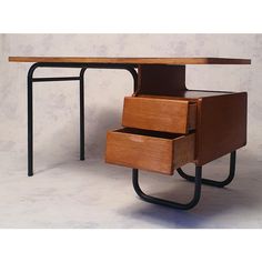 a wooden desk with two drawers on each side and a metal frame around the top