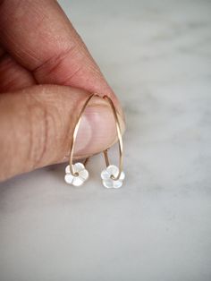 "Gold Filled Hoop Earrings, Tiny White Mother of Pearl Flower Hoop Earrings, Gold Hoop Earrings, Gold Earrings, Flower Hoops, Bridal Earrings, Gift for Her, Romantic Earrings, Feminine Earrings, Small Hoops, Dainty Earrings, MOP Earrings Adorable, feminine and lightweight 14k gold filled hoop earrings with the sweetest and tiniest carved white mother of pearl flowers. D E T A I L S: => Metal Type - 14k Gold Filled => Hoop size - Approx. 2 cm in diameter => Length - Approx 2 cm / 0.78\" Tiny Delicate Hoop Jewelry, Delicate Tiny Hoop Jewelry, White 14k Gold Filled Hoop Earrings, Delicate Flower Charm Hoop Earrings, Dainty White Hoop Jewelry, Dainty Hoop Earrings With Flower Charm, Delicate Hoop Jewelry With Flower Charm, Dainty Hoop Jewelry With Flower Charm, Everyday Flower Charm Hoop Earrings