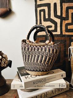 A beautiful authentic one-of-a-kind handwoven basket tote handmade in Bogatanga. Each bag is beautifully woven by hand with thick, natural and dyed elephants grass to create a beautiful pattern and leather wrapped handles. Size: 12”H x 10”W, 5”base. Size may vary slightly. *One-of-a-kind, 1 of 1. Brown Handwoven Top Handle Bucket Bag, Brown Handwoven Basket-shaped Bucket Bag, Artisan Handwoven Bucket Bag For The Market, Artisan Handwoven Bucket Bag For Market, Handwoven Rattan Basket Shoulder Bag, Bohemian Handwoven Bucket Bag For Shopping, Handwoven Natural Fiber Bucket Bag For Shopping, Handwoven Rattan Bucket Bag, Artisan Jute Straw Bucket Bag