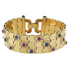 This vintage Retro Era 18KT yellow gold cabochon ruby and blue sapphire bracelet features a stunning 6.00CT-TW weight of cabochon rubies and sapphires. This is a significant amount of precious gems, making this piece both valuable and visually striking. You can proudly wear this bracelet knowing you have a rare and exquisite piece of jewelry on your wrist. 56.11 Grams Blue Sapphire Bracelet, Cabochon Ruby, Retro Bracelet, Retro Era, Yellow Gold Bangle, Diamond Cocktail Rings, Sapphire Bracelet, Gold Bangle Bracelet, Yellow Gold Bracelet