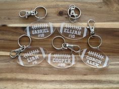 six clear keychains with personalized footballs printed on the front and back