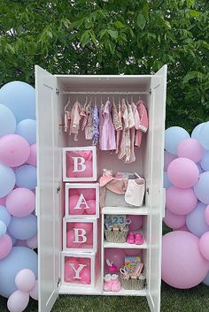 a pink and blue baby's closet with balloons in the background