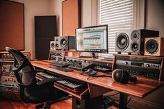 a home recording studio with multiple monitors and sound equipment