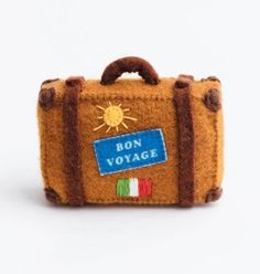 a small suitcase with the words bon voyage written on it's front and side