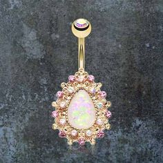 an opal belly ring with pink and white stones