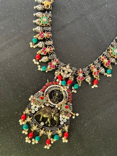 Be Classy, Be Beautiful!! The gorgeous necklace is beautifully handcrafted by our skilled Indian craftsmen from Jaipur in dual-tone polish. Notice the beautiful embellishments on an antique necklace.  Material: Brass with gold and silver plating, Kundan stones, multi coloured beads, stones  Comes with a hook closure.  The gorgeous antique pendant at the bottom with elegant elephant design adds a perfect glamour to the vintage embellished necklace. Dual-tone Pendant Jewelry For Festivals, Multicolor Necklace With Intricate Design For Ceremonial Occasions, Ceremonial Multicolor Necklace With Intricate Design, Ornate Multicolor Jewelry With Intricate Design, Dual-tone Temple Jewelry Pendant, Silver Dual-tone Kundan Necklace Temple Jewelry, Dual-tone Kundan Necklaces For Rituals, Ceremonial Temple Jewelry Dual-tone Necklaces, Dual-tone Necklaces For Ceremonial Festivals