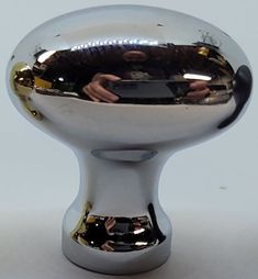 a close up of a shiny metal object on a white surface with no people around it