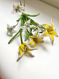 some flowers that are sitting on a table with white and yellow stems in the middle