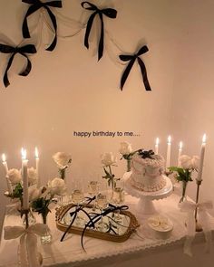 a table topped with a cake and candles