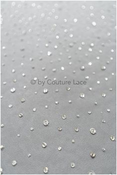 water droplets are on the surface of a gray cloth with white dots and black edges