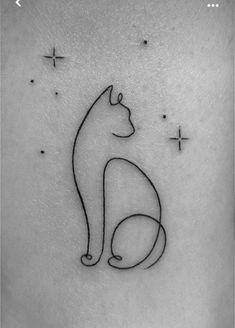 a black and white photo of a cat tattoo