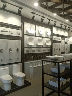 a bathroom filled with lots of white toilets