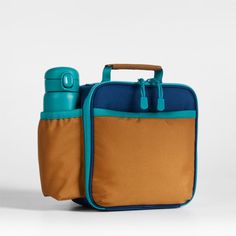 A fun and functional lunch box that's built to handle all the thrills and spills of the day. Combining colorblocks of navy and ocher with pops of aqua trim, our bag is constructed of food-safe and supremely durable polyester made from recycled water bottles. It's also lightweight and easy to clean, plus roomy enough to hold multiple storage containers. An insulated lining keeps meals just the way your kid likes them—hot, cold or somewhere in between. An outer pocket safely stows a napkin, utensi Functional Multicolor Lunch Box For Everyday Use, Functional Multicolor Lunch Box For Travel, Functional Rectangular Lunch Bag For Back To School, Blue Functional Lunch Bag For Everyday Use, Functional Blue Lunch Bag For Everyday Use, Functional Blue Lunch Bag, Blue Portable Lunch Bag For Everyday Use, Portable Blue Lunch Bag For Everyday Use, Functional Multicolor Lunch Box For School