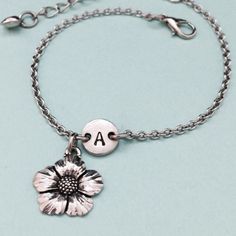 Flower charm bracelet with hand stamped initial. Bracelet size is 6 1/2 inches with 2 inch extender. If you need a larger size please message me. *Initial charm is antique silver pewter 9mm *Flower charm is antique silver pewter *Your purchase will arrive packaged in a cute gift box and I will include a message by request. Add on a birthstone charm for $3.00 https://www.etsy.com/listing/235600956 *Go back to Toodaughters https://www.etsy.com/shop/Toodaughters Personalized Silver Flower Bracelets, Personalized Silver Flower Bracelet, Silver Personalized Flower Bracelet, Flower Charm Bracelet, Bracelet Flower, Bracelet Initial, Personalized Bracelet, Cute Gift Boxes, Initial Bracelet