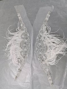 "These gorgeous bridal straps (set of 2) are made of rhinestones, frost stones, pearls, beads and ostrich feather on tulle base. SOLD AS A SET OF TWO. Dimensions: Width at centre (from top till the bottom of hanging beads) - 6 inches Width at centre (from top till the bottom of rhinestone flower) - 3.5 inches Width at edge - 1/2 inches The straps come without any hook or eye and can be stitched to the gown, but we can add hooks at each end to make detachable. Customisation in length and color av Fitted Rhinestone Bridal Accessories For Party, Fitted Bridal Accessories With Rhinestones For Party, Elegant Embellished Bridal Accessories For Ceremony, Elegant Beaded Fitted Bridal Belt, Elegant Beaded Bridal Belt, Elegant Fitted Bridal Accessories With Rhinestones, Elegant Embellished Bridal Belt For Evening, Elegant Embellished Fitted Bridal Accessories, Elegant Pearl Embellished Wedding Dress For Party