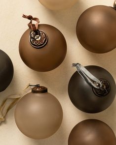 several brown and white ornaments are arranged on a table top, including one ornament