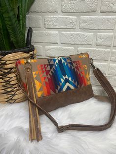 *New* XL Ruby Crossbody bag: ~Made with Pendleton wool in Pilot Rock pattern•saddle brown two tone genuine leather•1 lining zippered pocket •lined with cream waterproof canvas•antique bronze hardware •11” tassel zipper pull•adjustable crossbody strap is removable with swivel clasps, Extends from 54” to 30”•Measures 9”h x 14”wAll items are sewn together on an industrial machine using quality thread and interfacings for added strength and structure!Pendleton wool is woven in the US, based in Portl Fall Leather Trim Crossbody Shoulder Bag, Fall Shoulder Bag With Leather Trim, Crossbody Shape, Brown Crossbody Bag With Zipper Pouch, Brown Clutch Bag With Zipper Pouch, Brown Clutch Shoulder Bag For Travel, Fall Travel Clutch Shoulder Bag, Brown Bags With Zipper Pouch For Everyday, Brown Satchel With Zipper Pocket For Fall, Everyday Brown Bag With Zipper Pouch