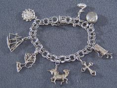 I am offering you this spectacular vintage sterling silver (tested positive for sterling silver 925 content) mixed themed charm bracelet. This is a loaded charm bracelet having 8 unique mixed theme charms . It is on a classic wide multi leveled linked charm bracelet , the previous owner had several years of collecting here !! One is an actual locket that opens, that has room for 2 pictures. It measures app. 7 inches long , and is app. 1 3/4 inches at it widest dangle point. It weighs app. 30 gra Sterling Silver Vintage Charm Bracelet Gift, Sterling Silver Vintage Charm Bracelet For Gift, Sterling Silver Vintage Charm Bracelet As A Gift, Unique Nickel-free Silver Charm Bracelet, Unique Silver Nickel-free Charm Bracelet, Silver Sterling Vintage Charm Bracelet, Silver Sterling Silver Vintage Charm Bracelet, Sterling Silver Dangle Charm Bracelet With Vintage Charm, Vintage Sterling Silver Charm Bracelet For Jewelry Making