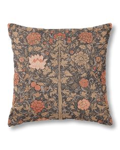 a decorative pillow with an orange and brown flower pattern on it's front side