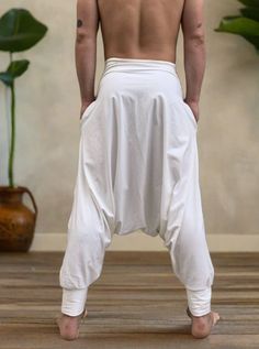 Handmade low drop harem pants with an elastic waistband and inner pockets in ivory white. This piece is a conscious creation with pure beautiful energy. -unisex- handmade in one of our studios in Brooklyn, NY, USA- kundalini yoga style- flowing relaxed fit- 2 side pocketsGreat for Yoga, Dance, Exercises, Meditations, Kundalini Yoga Practice and beyond...Materials: High quality ivory white stretch cotton blend.Measurements: Fits: S, M, M/L-Length: 41" (~104 cm)-Waist: 30" - 40" (76 - 100 cm)Model White Harem Pants For Yoga In Summer, White Relaxed Fit Harem Pants For Yoga, White Baggy Harem Bottoms, White Baggy Harem Pants, White Bohemian Style Relaxed Fit Harem Pants, White Wide Leg Harem Pants For Loungewear, White Bohemian Harem Pants For Yoga, White Bohemian Yoga Pants, White Cotton Relaxed Fit Harem Pants