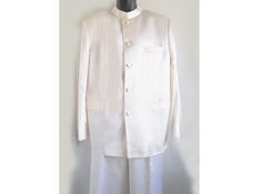 "A wonderful white satin suit, in near mint condition. Great for a special occasion or wedding! Fully lined, well made, with covered buttons. My manikan is only a half form, and it has no back, only a frontso the back of garments often look odd. You will have to excuse the photos because of that. Only two flaws I could find is a small feint yellowish mark at the waistband of the trousers. See close up. Also another small brownish stain on one hip about the size of a small lentil. I have not had Semi-formal White Sets With Buttons, White Buttoned Semi-formal Sets, White Semi-formal Sets With Buttons, Formal Fitted White Bandhgala, White Fitted Bandhgala For Formal Occasions, Fitted White Satin Sets, White Fitted Satin Sets, Fitted White Silk Suits, White Fitted Silk Suit