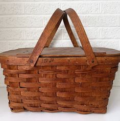 a wooden basket sitting on top of a white table