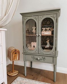 a green cabinet with glass doors in a room