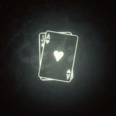 two playing cards are glowing in the dark