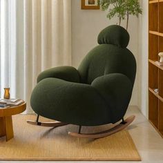 a living room with a rocking chair and bookshelf