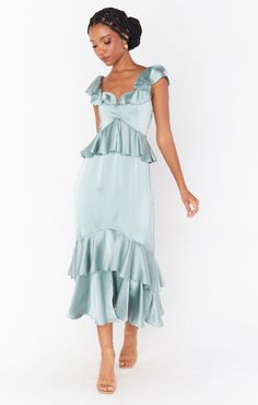 Feminine and flirty, this silver sage ruffled tiered midi dress is as romantic as they come. The ruffles and flutter sleeves make this dreamy dress the utmost flattering, and smocked back ensures the perfect fit. Slate Blue Bridesmaid Dresses, Satin Ruffle Dress, Mint Green Bridesmaid Dresses, Teal Bridesmaid Dresses, Silver Bridesmaid Dresses, Blue Ruffle Dress, Sage Bridesmaid Dresses, Formal Wedding Guest Dress, Sage Green Bridesmaid Dress