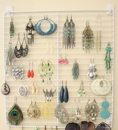 a wall mounted jewelry rack with sunglasses and necklaces