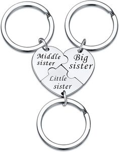 two heart shaped key chains with the words middle sister, big sister and little sister on them