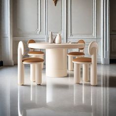 a white table with four chairs around it