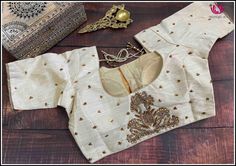 This is a cream color raw silk blouse with golden chumki work. This has a beautiful back neck with dori in the back and has a standard front opening. It fits size 40. It is a classy blouse perfect to pair with silk sarees. Size: 40 Please note: Color may vary slightly from the picture. Loose threads and pulled threads are common in embroidered clothing and it is not a defect. Cream Blouse For Saree, Cream Raw Silk Saree Blouse Piece, Cream Raw Silk Blouse Piece For Saree, Bollywood Style Raw Silk Blouse For Wedding, Elegant Dola Silk Blouse For Wedding, Wedding Blouse With Zari Work In Chanderi, Wedding Chanderi Blouse With Zari Work, Chanderi Blouse Piece With Zari Work In Cream, Cream Chanderi Blouse Piece With Zari Work