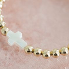 Some of the most lovely things are the most simple—and our Cross Bead Bracelet is no exception. A small white pearl cross, made with white pearl of the sea. Small 14k gold filled round beads, made with metal of the earth. These simple, natural materials find a home together in this piece, and in that harmony, you can find a powerful reminder: Christ gave His life for you. The Cross Bead Bracelet is the perfect addition to your favorite bracelet stack. We love this bracelet paired with our Marian Necklace Extender, Local Jewelry, Lovely Things, Bracelet Stack, Silver Roses, Silver Rose Gold, White Pearl, Bead Bracelet, Bracelet Gift