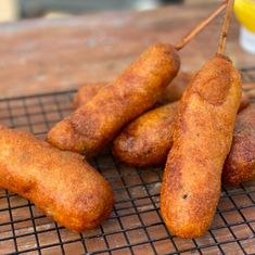 there are several sausages on the grill ready to be cooked