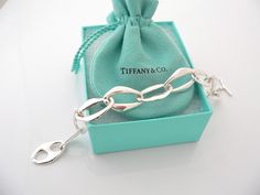 Have you been searching for a piece of Tiffany jewelry that made the brand an icon? You just stumbled upon one of them! Offered for sale is a gorgeous Tiffany & Co. Silver Peretti Aegean bracelet. If you must have just one Tiffany piece ... this should be at the top of your preference list! :) Very substantial and unique Tiffany piece that you will get your money's value for. It is a wonderful bracelet that looks very contemporary, elegant and super chic. The piece looks great worn alone, but wo Box Pouch, Tiffany Jewelry, Bracelet Bangle, Tiffany & Co., Link Chain, You Must, Bangle Bracelets, Gift Box, Bangles