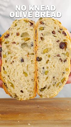 a person holding a sandwich in their hands with the words no knead olive bread on it