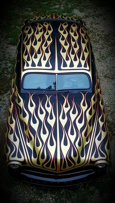 an old car with flames painted on it