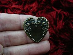 (Internal #B-Heart-13)  This is a heart shaped, piece of reproduction Victorian stamped brass with scrolled flower and dot design, made into a pin/pendant (glued on the back).  This gorgeous reproduction Victorian stamped brass is antiqued, then buffed to create some shine.  This pin/pendant is handcrafted. WE SHIP WORLDWIDE! Other accepted payment: Credit card (Mastercard/Visa/Discover) inquire for details. Antique Heart Brooch For Wedding, Antique Heart-shaped Wedding Brooch, Vintage Heart-shaped Collectible Brooch, Vintage Heart Shaped Collectible Brooch, Collectible Vintage Heart-shaped Brooch, Antique Heart-shaped Brooch For Gift, Vintage Gold Heart Brooches, Antique Heart-shaped Brooches As Gifts, Ornate Antique Gold Brooch For Gift