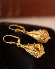 Intricate Filigree Mid-Century Drop Earrings in 14k Yellow Gold These Intricate Filigree Mid-Century Drop Earrings feature a vintage teardrop chandelier design 14 karat yellow gold. Royal filigree metalwork wears around each pear-shaped charm. Two seashell engravings decorate the front of the lever backings. A milgrain rope and openwork design. The drops measure 1.75 inches long and .25 inches wide. Romantic, radiant, and truly unique. French-inspired Mid-Century drops to lighten up your look! C Traditional 14k Gold Drop Earrings, Fine Jewelry Bridal Earrings For Formal Occasions, Formal Bridal Fine Jewelry Earrings, Formal 14k Yellow Gold Bridal Earrings, Luxury Earrings With Intricate Design, Luxury Hallmarked Yellow Gold Bridal Earrings, Luxury Yellow Gold Hallmarked Bridal Earrings, Formal Teardrop Pierced Bridal Earrings, Formal Teardrop Bridal Earrings Pierced