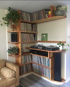 a record player is sitting in front of a shelf full of records