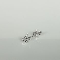 A PAIR of tiny sterling silver leaves on a stem sear studs. Size: 5 x 7 mm These earrings are made of 925 hypoallergenic sterling silver. All my pieces are sent in a gift box. I can include a personal message from you if needed. You are welcome to contact me at... bhavnakwintra1956@gmail.com More hoops: https://www.etsy.com/your/shops/TheSilverGame/tools/listings/section:26305414 More earrings: https://www.etsy.com/your/shops/TheSilverGame/tools/listings/section:26308789 Ear climbers: https://ww Silver Leaf Minimalist Earrings, Silver Leaf-shaped Minimalist Earrings, Minimalist Silver Leaf Earrings, Minimalist Sterling Silver Leaf-shaped Earrings, Minimalist Leaf-shaped Sterling Silver Earrings, Silver Hypoallergenic Ear Climbers As Gift, Hypoallergenic Silver Ear Climbers As Gift, Hypoallergenic Silver Ear Climbers For Gift, Delicate Silver Ear Climbers For Gift