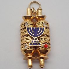 "Vintage 14k (.585) yellow gold figural charm or pendant in filigree designs, featuring Judaic Torah scroll holder, decorated with blue enamel. The three of four red cabochon accents are missing. This darling charm is 1 1/4\" long, 5/8\" wide, weighing 4.7 grams. EA4883" Antique Enamel Charms Jewelry, Ornate Engraved Enamel Jewelry, Ornate Jewelry Charms For Collectors, Traditional Gold Jewelry Souvenir, Traditional Gold Souvenir Jewelry, Traditional Gold Jewelry For Souvenir, Antique Gold Enamel Jewelry, Traditional Gold Jewelry As Souvenir, Ornate Collectible Charms Jewelry