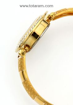 22 Karat Gold Watch - Titan Raga Watch - Womens Gold Watch With Cz 
  Diameter of the watch dial : 1.05 inches
  Please Note: The dial of the watch is NOT made of Gold, only the strap connecting (joining) the watch is made of Gold


Discover the allure of Indian craftsmanship with this exquisite 22 Karat Gold Watch from Titan Raga. Designed for women who appreciate the beauty of fine jewelry, this watch seamlessly blends traditional elegance with contemporary style. 
 
 Featuring a sleek and fem Gold Diamond Watch With Metal Round Dial, Gold Round Watch With Subdials, Gold Watches With Subdials For Gift, Gold Watch With Metal Dial For Anniversary, Gold Round Watch With Skeleton Dial, Gold Jewelry And Watches With Round Metal Dial, Gold Jewelry And Watches With Metal Dial, Gold Watches With Metal Dial For Anniversary, Gold Round Skeleton Dial Watch