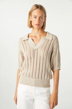 With the effortless drape of an open pointelle knit, our relaxed take on the classic polo is a surprisingly versatile piece. The johnny collar and feminine silhouette make it easy to pair with denim or layer under a blazer for a polished look. COLOR: PUMICE FIT & MEASUREMENTS: Body Length = 21 3/4" Chest = 19 1/4" Measurements taken from size 27 Cindy is wearing a size 25 and is 5'10" FABRIC & CARE: 100% Pima Cotton Dry clean or hand wash, dry flat. Made with love in Los Angeles Sweet Tee, Johnny Collar, Pointelle Knit, Denim Sweater, Feminine Silhouette, Classic Wardrobe, Polished Look, Denim Shop, Pima Cotton