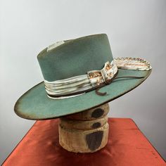 *PRICE INCLUDES $15 HAT BOX* Premium Wool Felt  4 1/4 Crown, 3 3/4 inch brim shown  Custom Color, Distressing, Band and Accessories Colors may vary slightly. Although each hat is unique a similar hat can be made in various sizes.  All Sales Final Western Style Flat Brim Top Hat For Kentucky Derby, Kentucky Derby Top Hat For Ranch Events, Curved Brim Hats For Rodeo And Kentucky Derby, Vintage Fitted Top Hat For Western-themed Events, Classic Handmade Hat With Flat Brim, Custom Brimmed Ranch Hats, Flat Brim Top Hat For Ranch And Kentucky Derby, Wide Brim Top Hat For Kentucky Derby, Artisan Style Brimmed Hats For Ranch