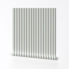 a white and green striped wallpaper with vertical stripes on the bottom half of it