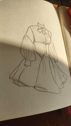 an open book with a drawing of a woman in a dress